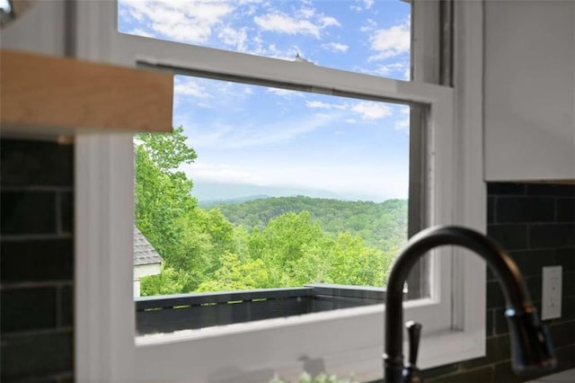 interior details featuring a wooded view