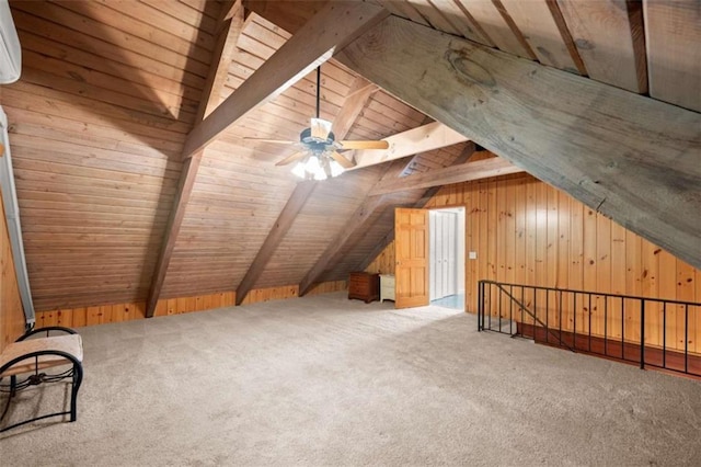 bonus room with wooden ceiling, ceiling fan, wooden walls, carpet flooring, and vaulted ceiling with beams