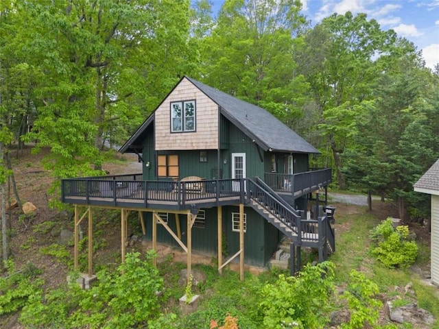 back of house featuring stairway and a wooden deck