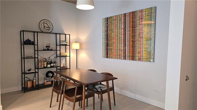 dining room featuring baseboards and wood finished floors