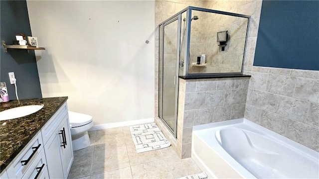 bathroom with vanity, baseboards, a stall shower, a garden tub, and toilet