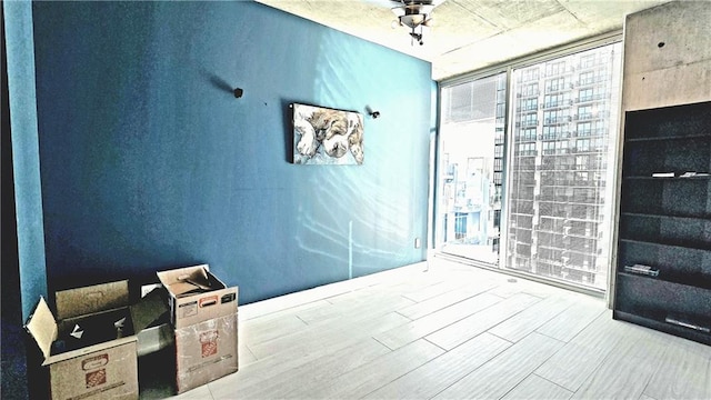 bathroom with floor to ceiling windows and wood finished floors