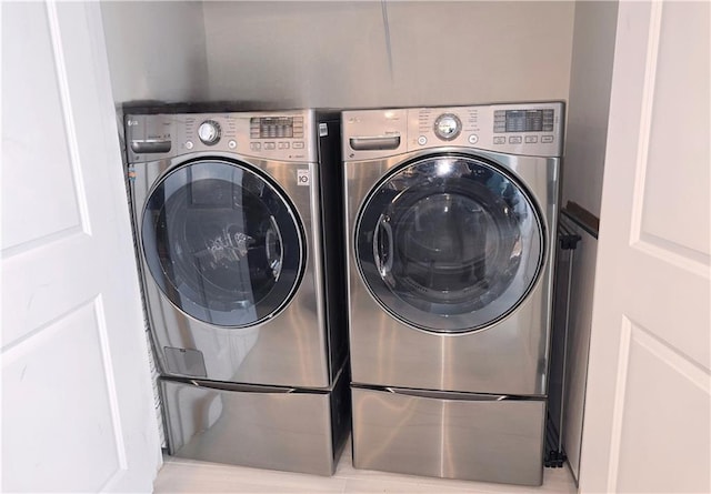 washroom featuring laundry area and washer and clothes dryer