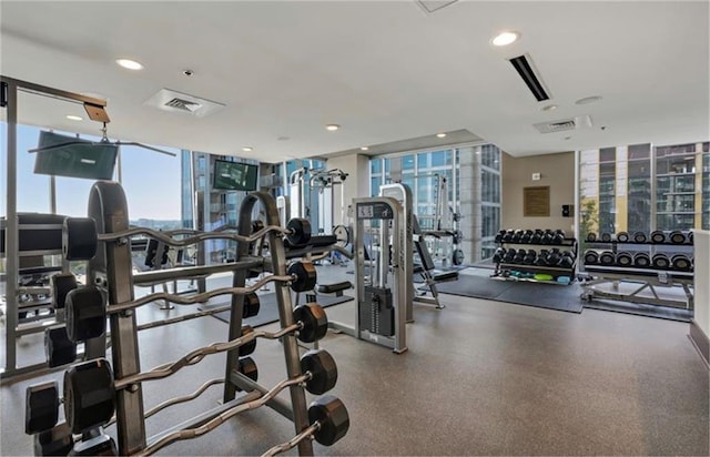 workout area featuring recessed lighting and expansive windows