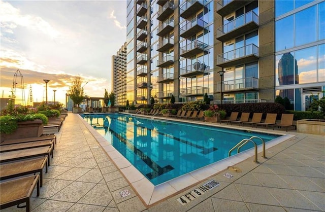 view of pool at dusk