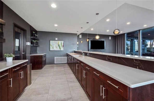 kitchen with visible vents, recessed lighting, a sink, light countertops, and decorative light fixtures