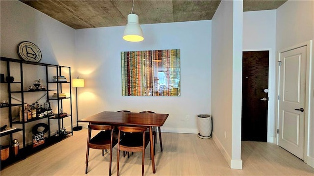 dining room featuring wood finished floors and baseboards