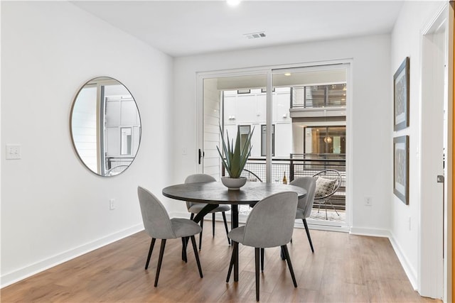 dining space with hardwood / wood-style flooring and plenty of natural light