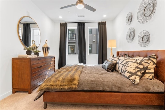 bedroom with ceiling fan and light carpet