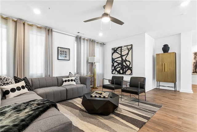 living room featuring ceiling fan and light wood-type flooring