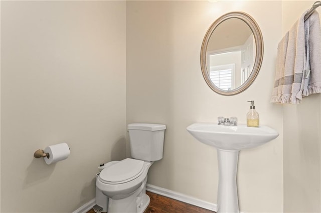 bathroom featuring hardwood / wood-style floors, sink, and toilet