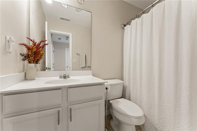 bathroom with vanity, walk in shower, and toilet