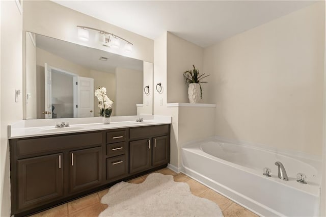 bathroom featuring vanity, tile patterned flooring, and a tub