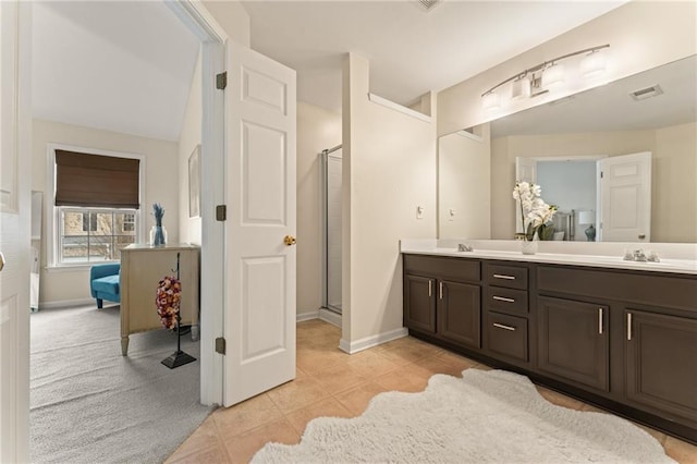 bathroom featuring vanity, tile patterned floors, and a shower with door