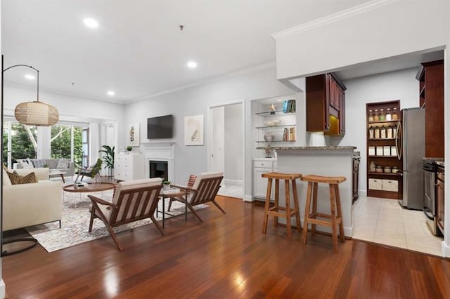 living room featuring wood-type flooring and ornamental molding