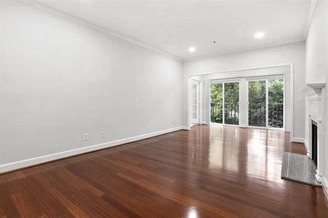 unfurnished living room with dark hardwood / wood-style floors and crown molding