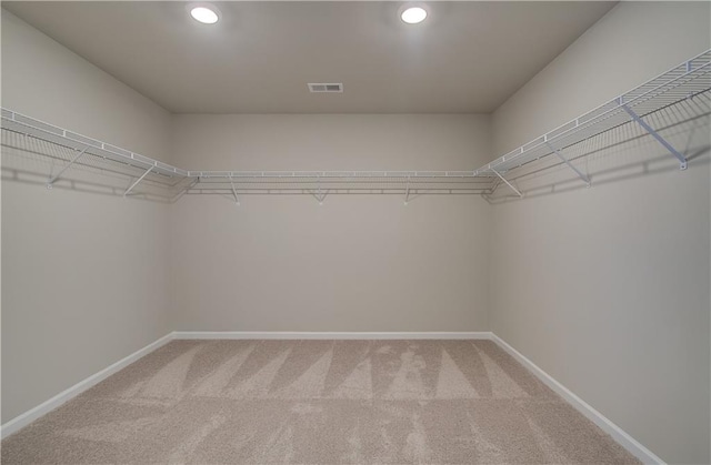 walk in closet featuring carpet and visible vents