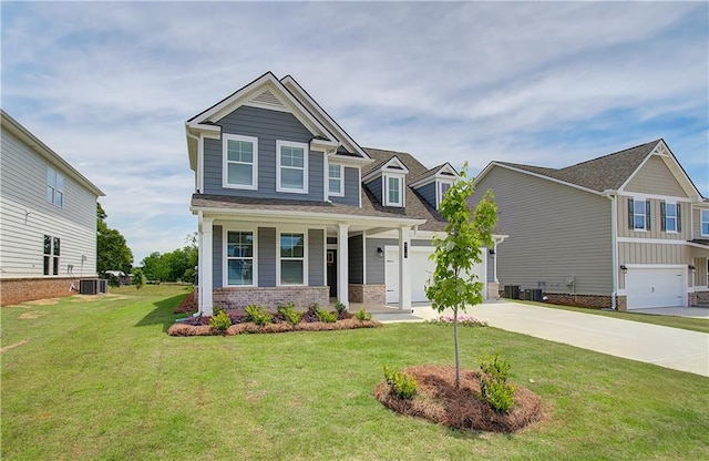 craftsman-style home with concrete driveway, brick siding, a front lawn, and central AC unit