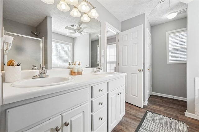 full bath featuring a sink, a wealth of natural light, a shower stall, and a ceiling fan