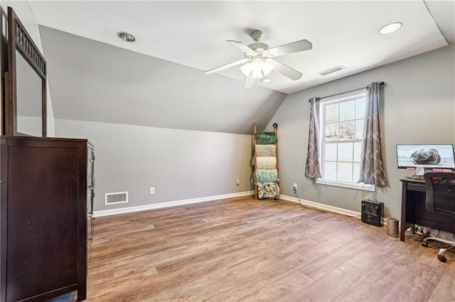 additional living space with lofted ceiling, baseboards, visible vents, and light wood finished floors