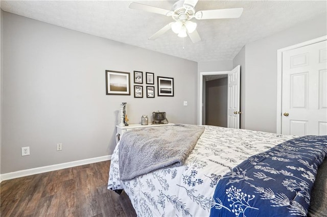 bedroom with ceiling fan, a textured ceiling, wood finished floors, and baseboards