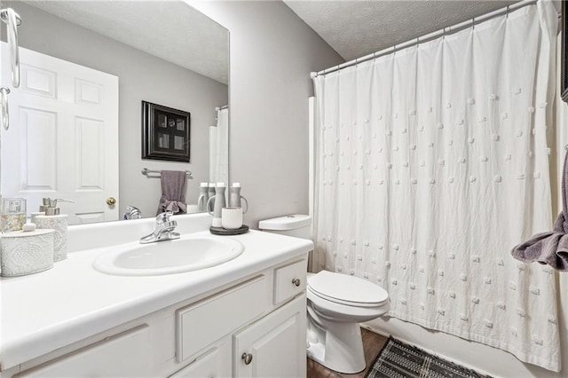 bathroom with toilet, a textured ceiling, and vanity