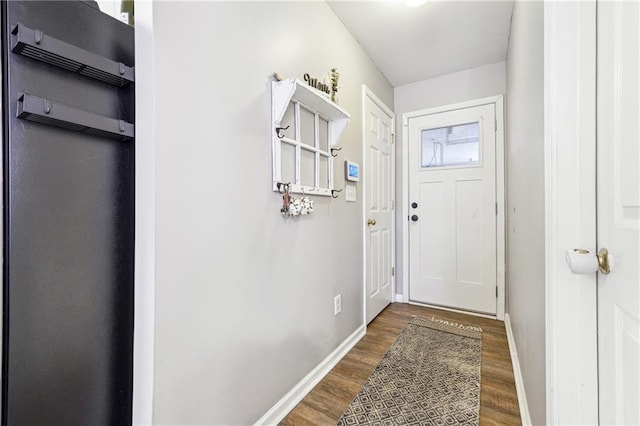 entryway featuring baseboards and wood finished floors