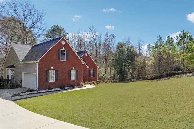 view of home's exterior with driveway, a yard, a garage, and brick siding