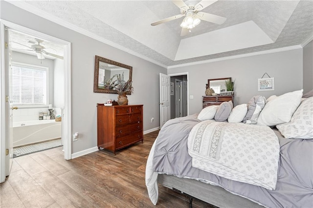 bedroom featuring baseboards, ornamental molding, a raised ceiling, and light wood-style floors