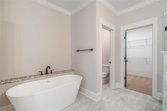 473 Nugget Rd, Carrollton, GA 30117 - full bathroom featuring ornamental molding, a freestanding bath, a spacious closet, and toilet