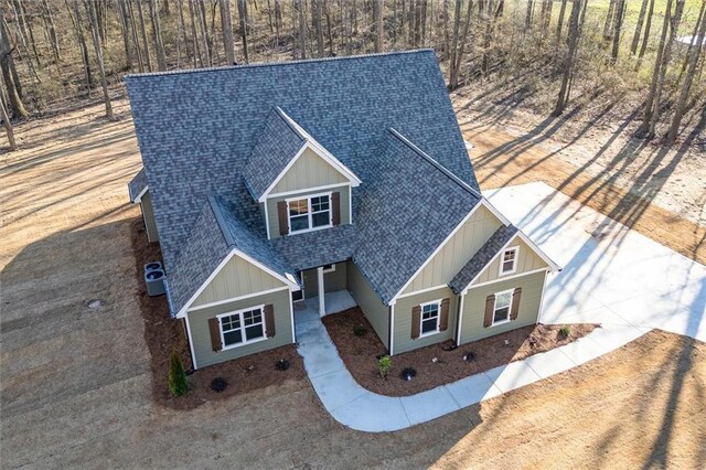 473 Nugget Rd, Carrollton, GA 30117 - view of front facade featuring central air condition unit, driveway, board and batten siding, and roof with shingles