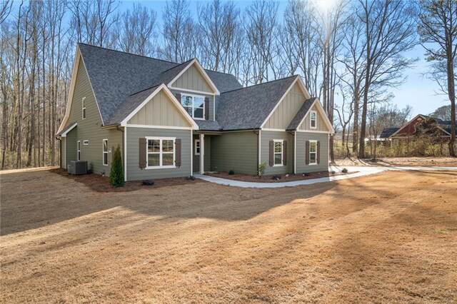 473 Nugget Rd, Carrollton, GA 30117 - craftsman inspired home with dirt driveway, central AC unit, board and batten siding, and a shingled roof