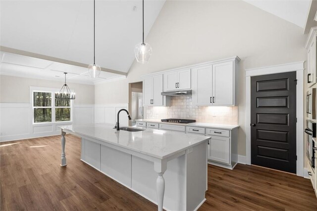 473 Nugget Rd, Carrollton, GA 30117 - kitchen with a kitchen island with sink, under cabinet range hood, stainless steel appliances, a sink, and white cabinets