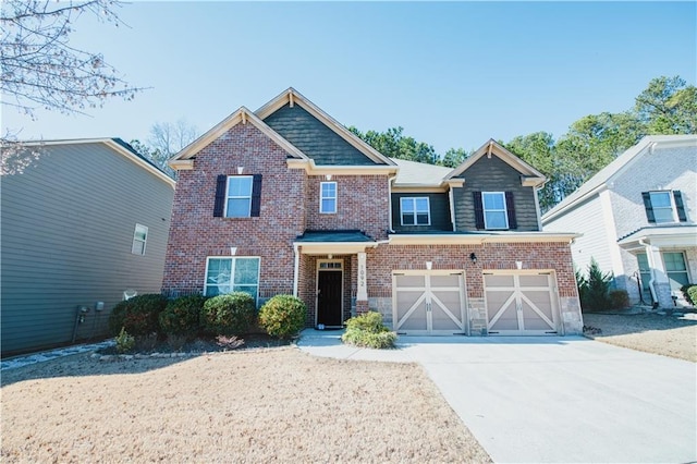 craftsman-style home featuring brick siding, an attached garage, and driveway