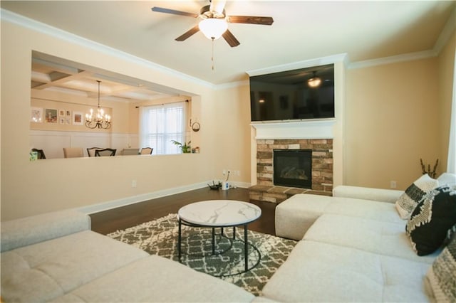 living area featuring beamed ceiling, coffered ceiling, wood finished floors, a fireplace, and crown molding