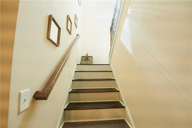 staircase featuring baseboards