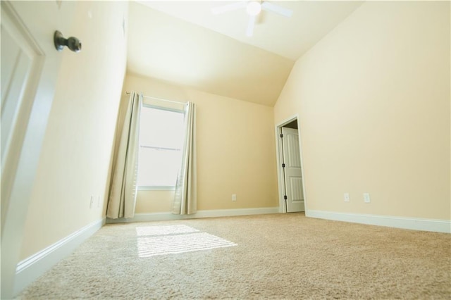 interior space featuring baseboards, lofted ceiling, carpet floors, and ceiling fan