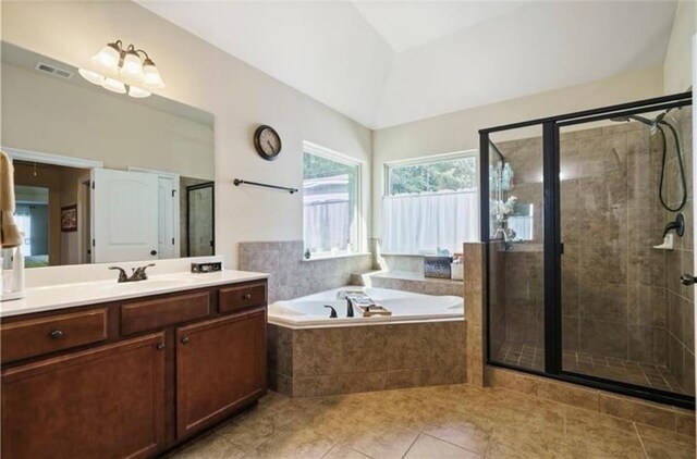 full bathroom featuring visible vents, a garden tub, vaulted ceiling, a stall shower, and vanity