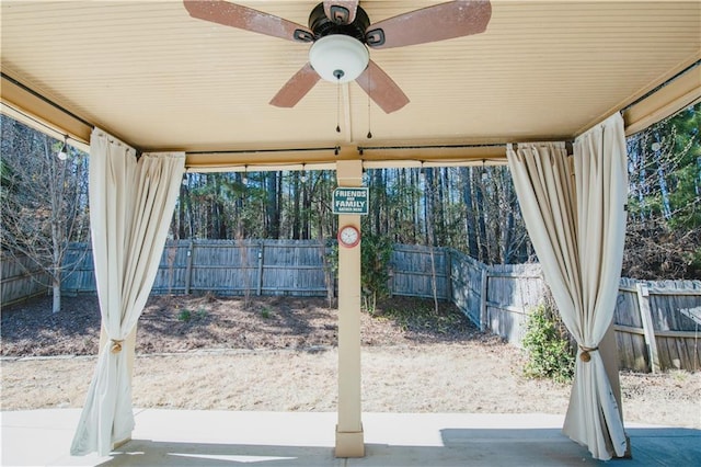 view of yard with a ceiling fan and fence private yard