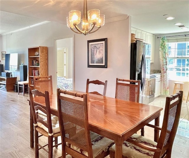 dining area featuring a chandelier, recessed lighting, light wood-style floors, and ornamental molding