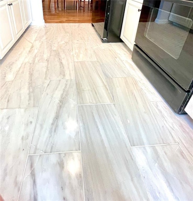 interior details with white cabinets and range