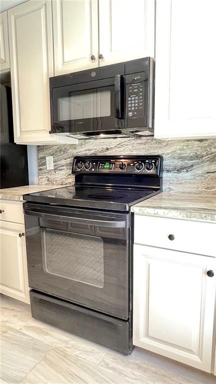 details with backsplash, light countertops, and black appliances