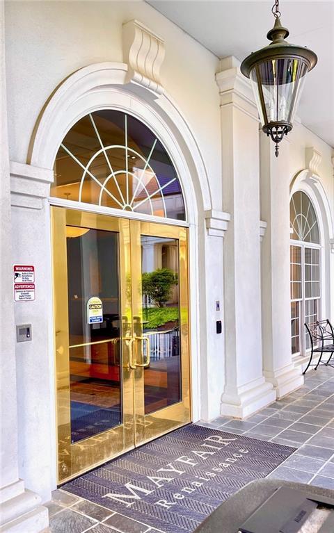 view of exterior entry featuring stucco siding