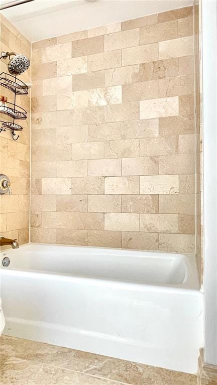 bathroom featuring shower / bathtub combination and toilet