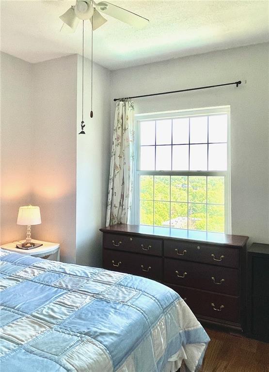 bedroom featuring dark wood-type flooring and a ceiling fan