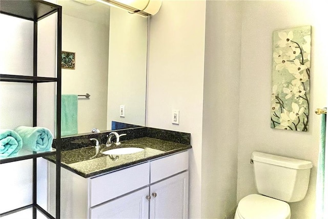 bathroom featuring toilet and vanity