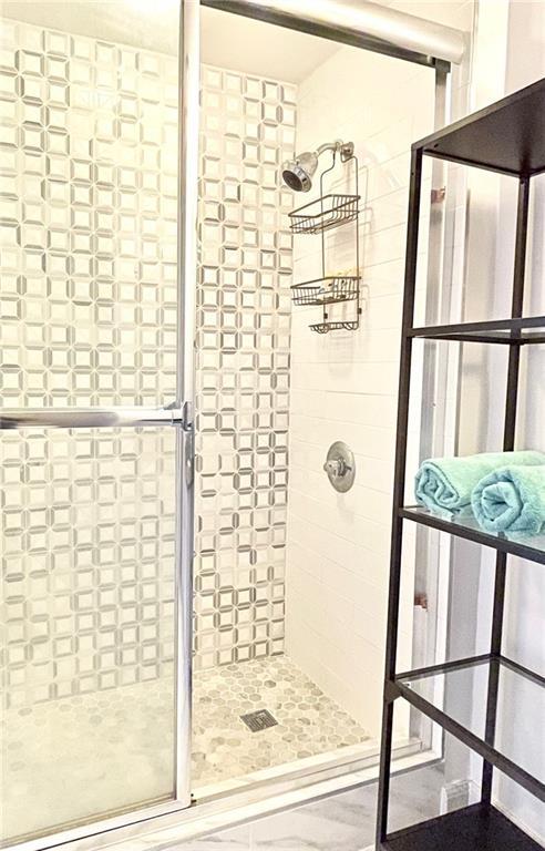 full bath with a shower stall