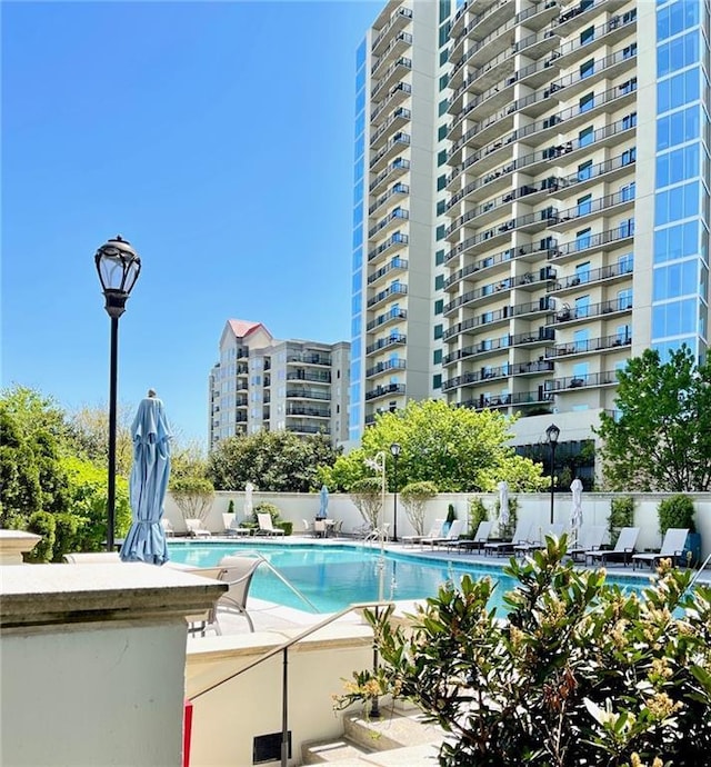 community pool featuring a patio area and fence