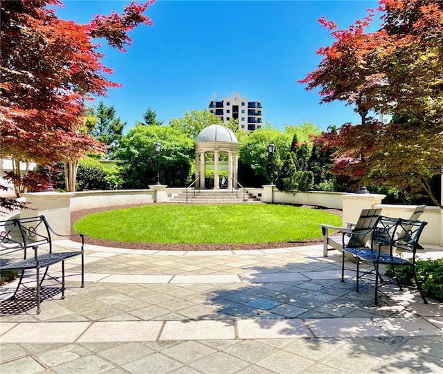 view of community featuring a yard and a patio area
