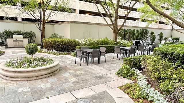 view of community featuring area for grilling, a patio, and outdoor dining area